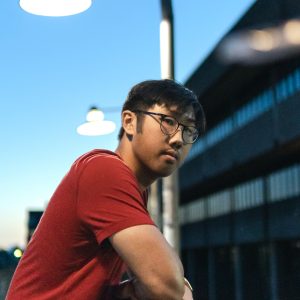 Student in red shirt by train