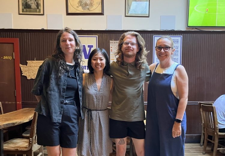 Four UWCHR staff members smile