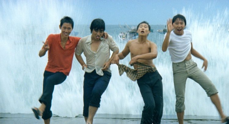 Teenage boys in wet clothes jumping in the surf in Taiwan. Still taken from the film The Boys from Fengkuei (1983).