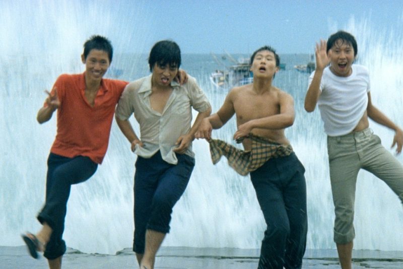 Teenage boys in wet clothes jumping in the surf in Taiwan. Still taken from the film The Boys from Fengkuei (1983).