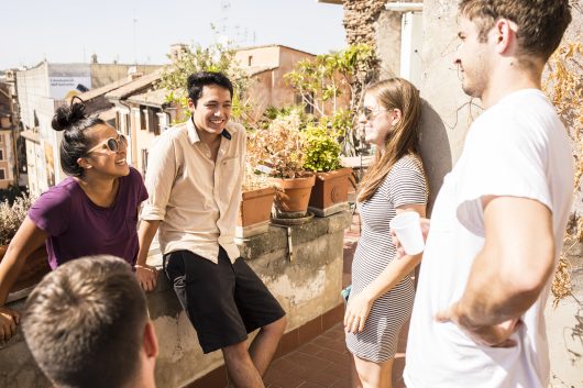 UW students chatting on a balcony in Rome as part of the UW Rome Center program.